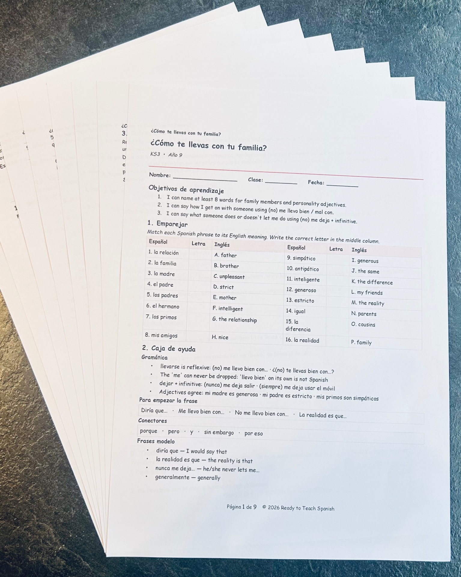 Printed Ready to Teach Spanish lesson sheets fanned out on a dark worktop
